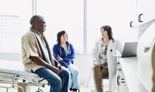 senior in exam office with provider