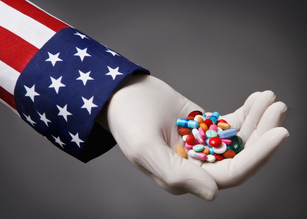 Arm with USA flag holding pills