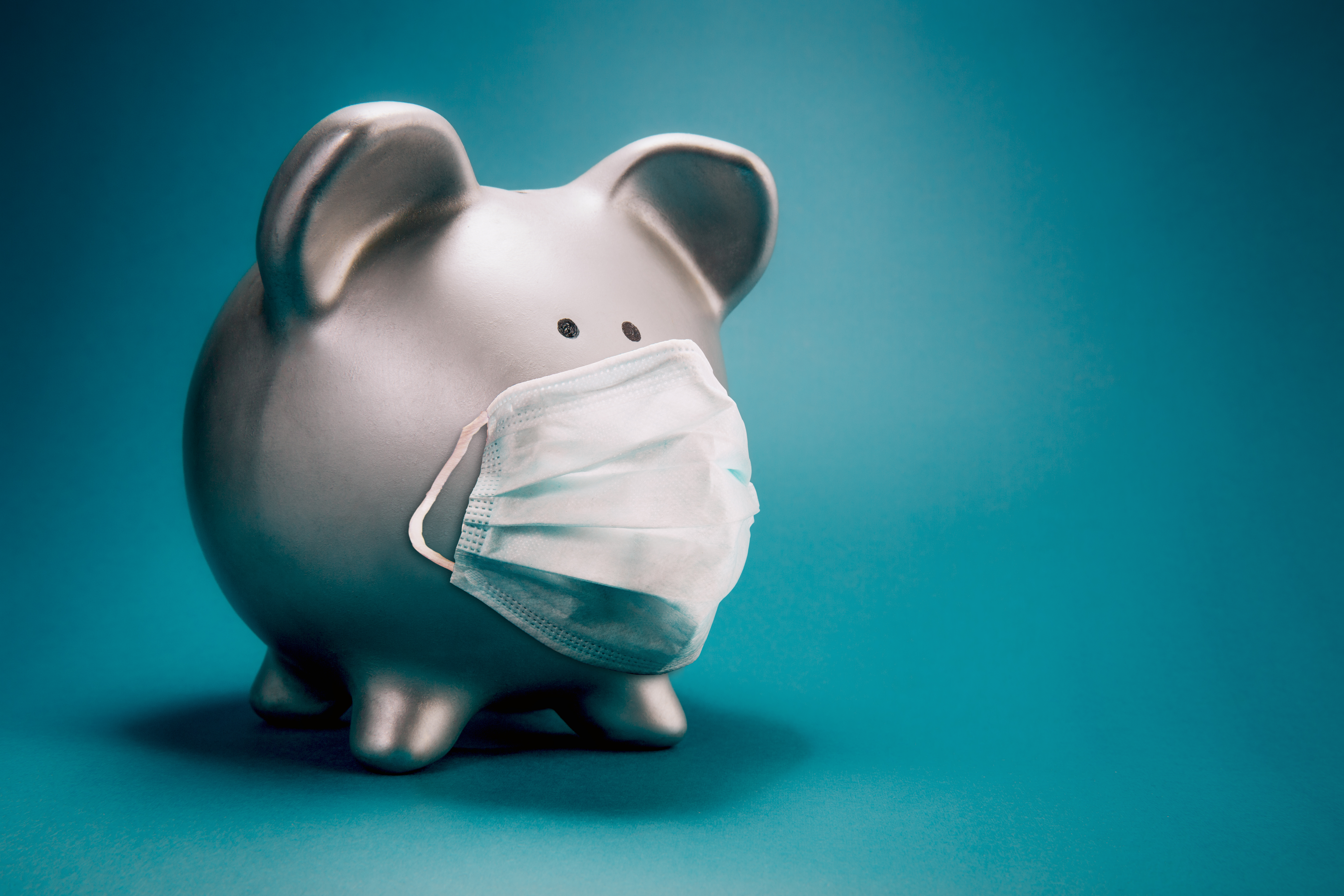 white piggy bank with a face mask
