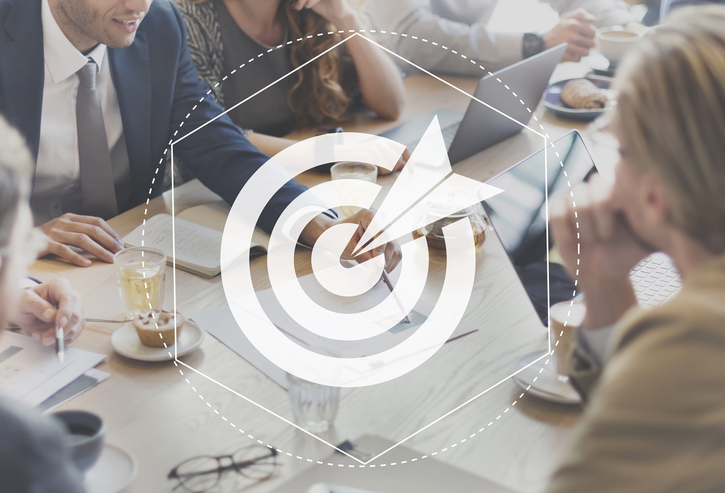 people around table talking with overlay of a target image